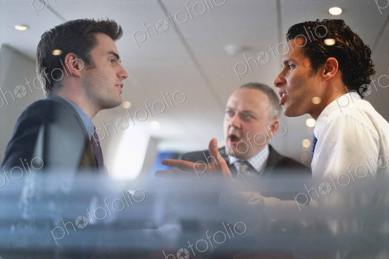 Caucasian businessmen arguing in office