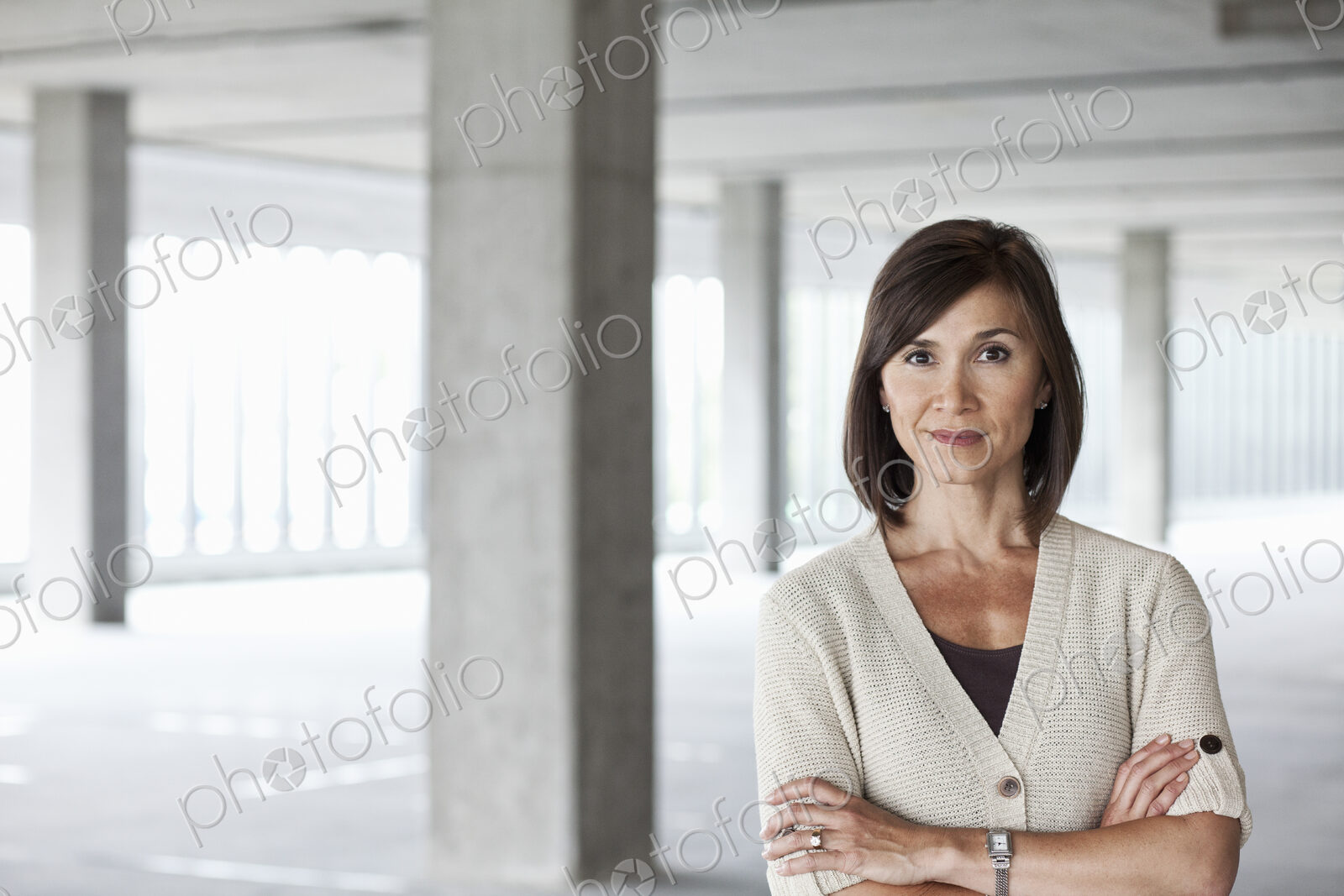 Caucasian businesswoman in a large empty raw office space.