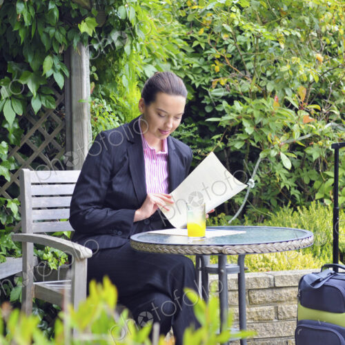 Caucasian businesswoman working in garden