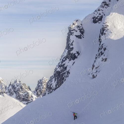 Caucasian climber scaling snowy mountain slope