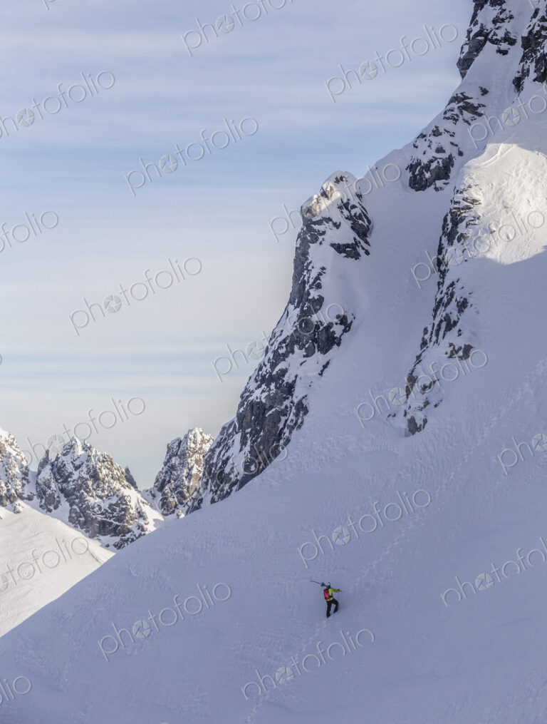 Caucasian climber scaling snowy mountain slope