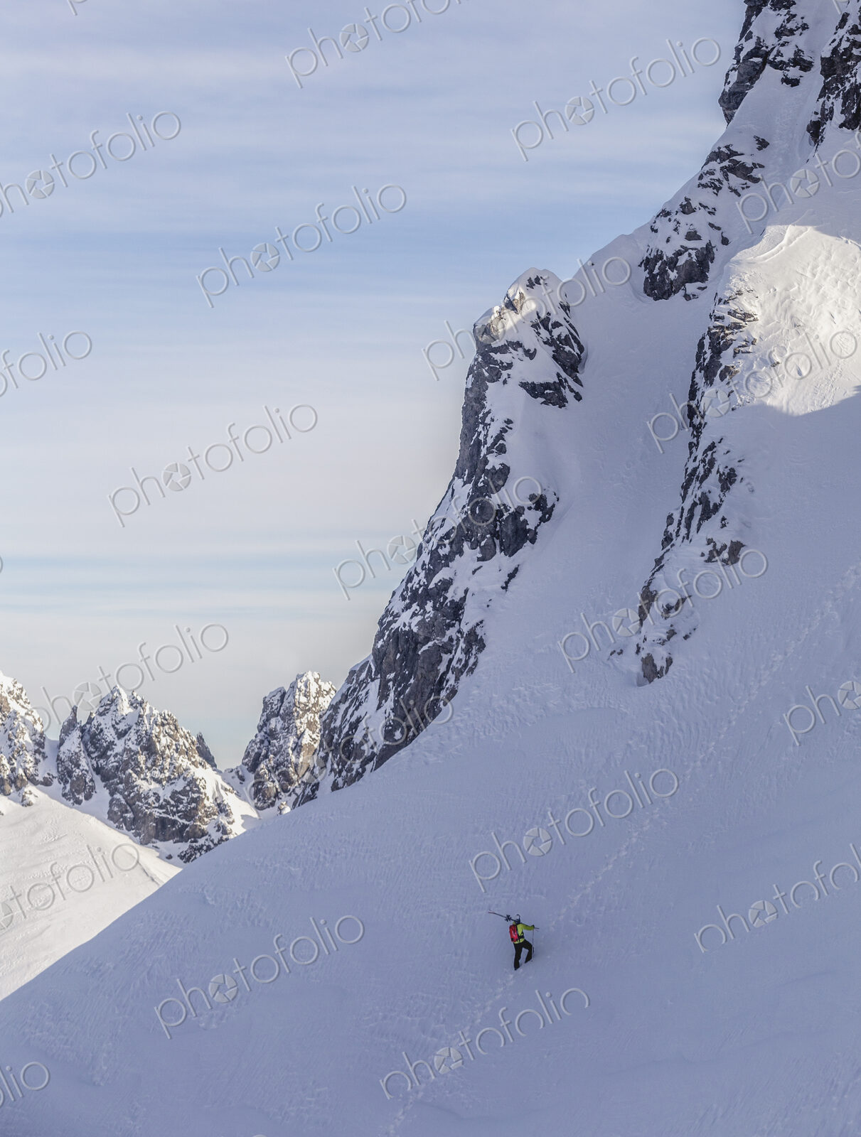 Caucasian climber scaling snowy mountain slope