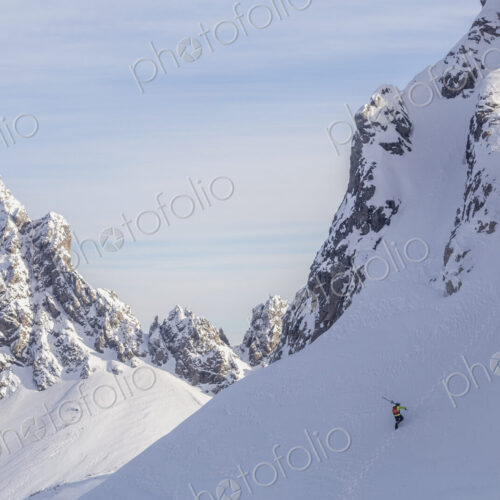 Caucasian climber scaling snowy mountain slope