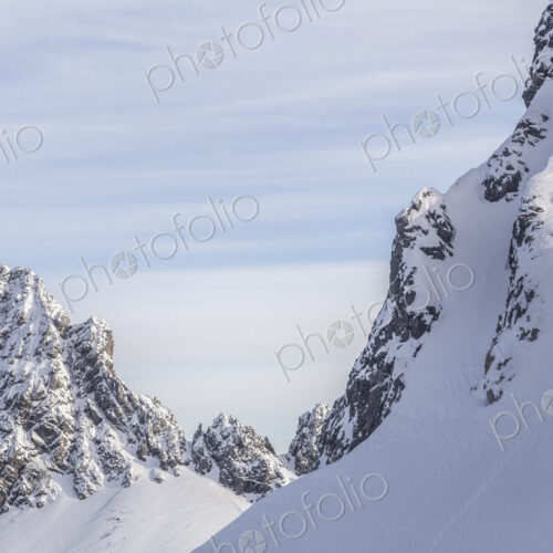 Caucasian climber scaling snowy mountain slope