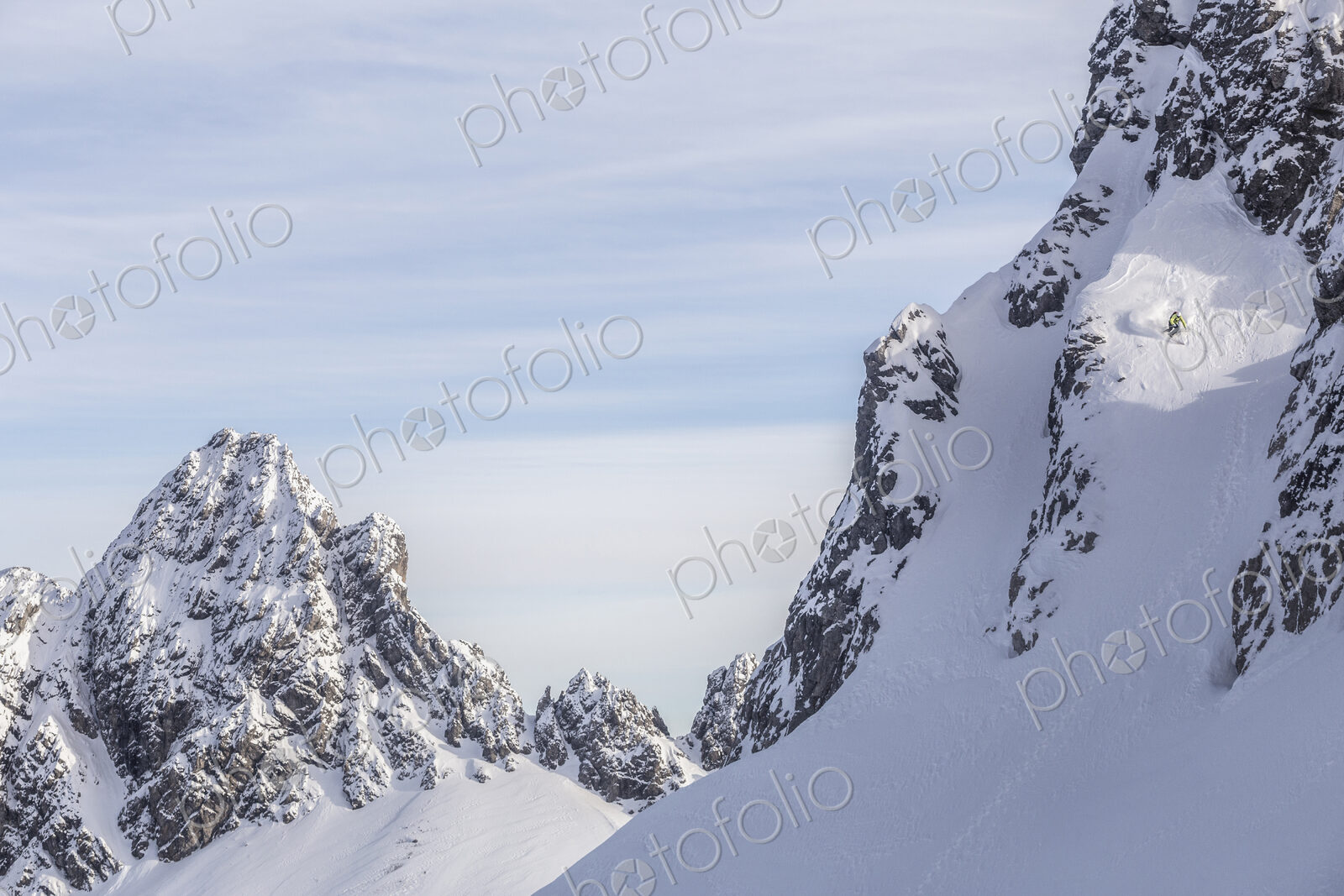 Caucasian climber scaling snowy mountain slope