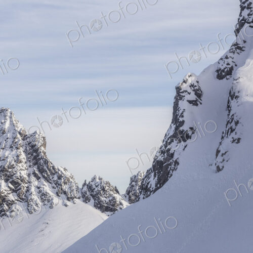 Caucasian climber scaling snowy mountain slope