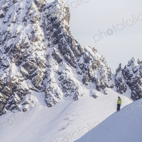 Caucasian climber standing on snowy mountain slope