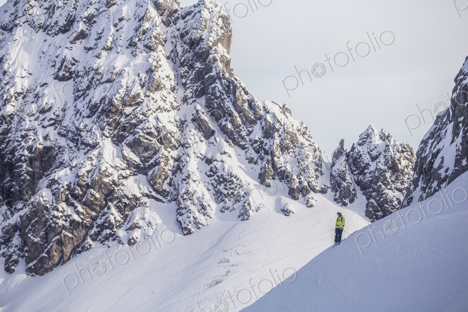 Caucasian climber standing on snowy mountain slope