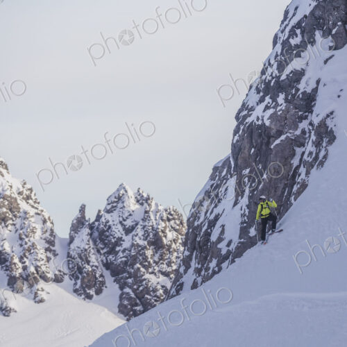Caucasian climber standing on snowy mountain slope