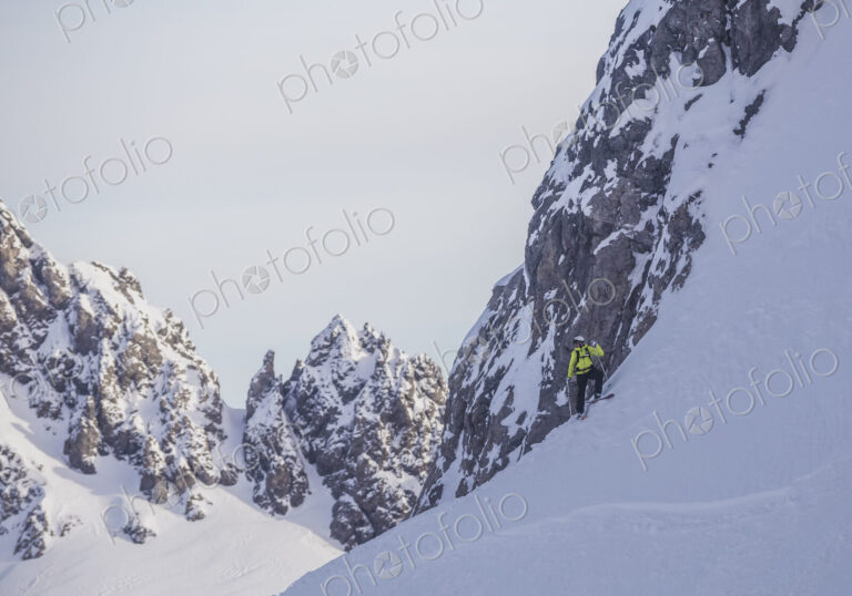Caucasian climber standing on snowy mountain slope