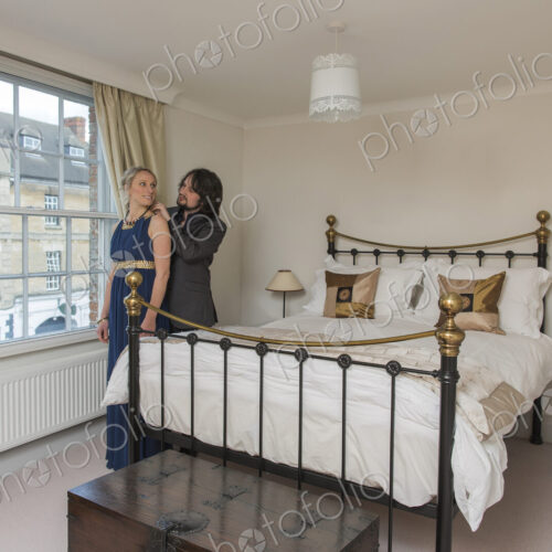 Caucasian couple dressing in bedroom