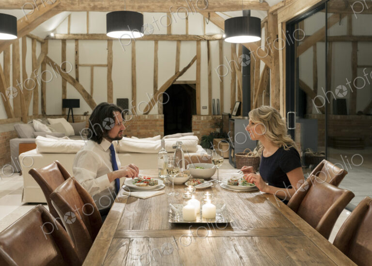 Caucasian couple in dining room of converted barn home