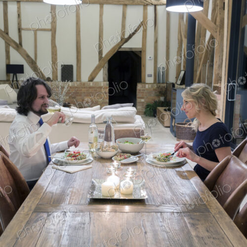 Caucasian couple in dining room of converted barn home Caucasian couple in dining room of converted barn home
