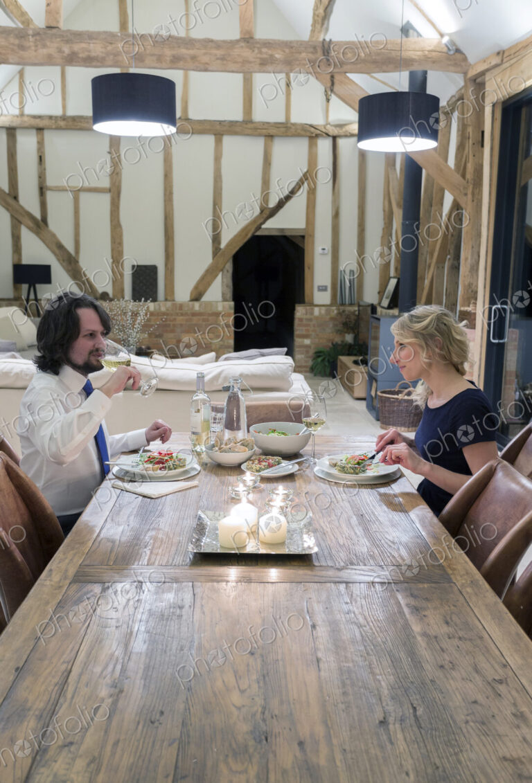 Caucasian couple in dining room of converted barn home