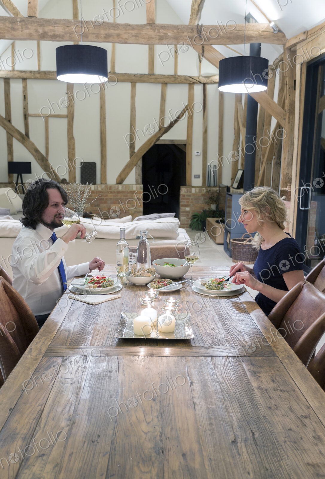 Caucasian couple in dining room of converted barn home