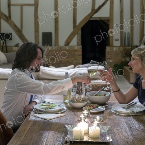 Caucasian couple in dining room of converted barn home Caucasian couple in dining room of converted barn home