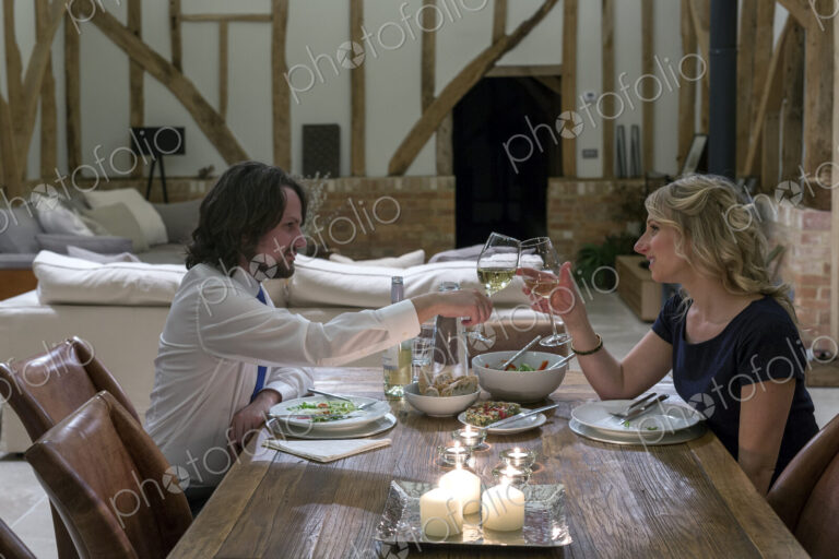 Caucasian couple in dining room of converted barn home