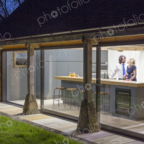 Caucasian couple in kitchen of converted barn home Caucasian couple in kitchen of converted barn home