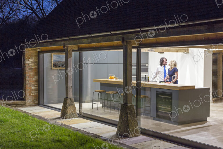 Caucasian couple in kitchen of converted barn home