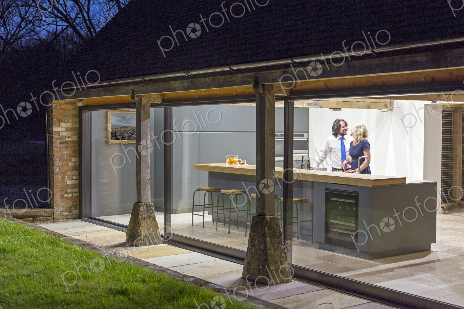 Caucasian couple in kitchen of converted barn home