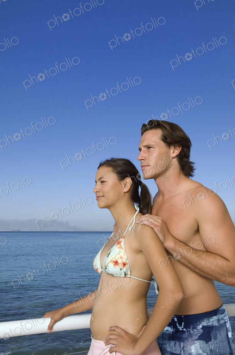 Caucasian couple standing on boat deck
