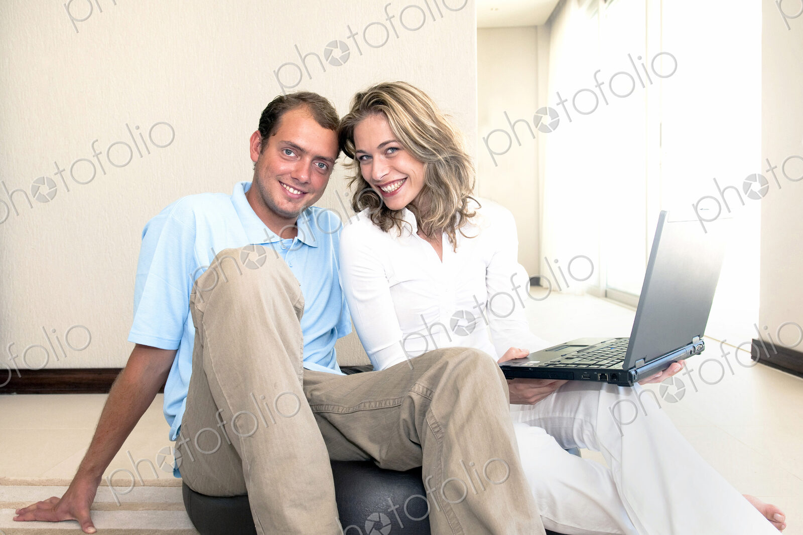 Caucasian couple using laptop on ball on floor