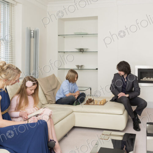 Caucasian family relaxing in living room Caucasian family relaxing in living room