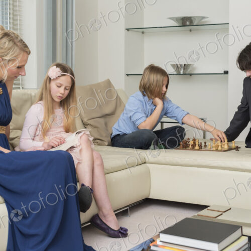 Caucasian family relaxing in living room Caucasian family relaxing in living room