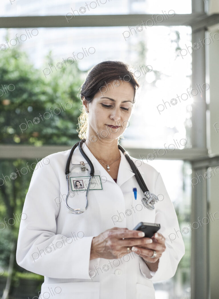 Caucasian female doctor in lab coat with stethescope.