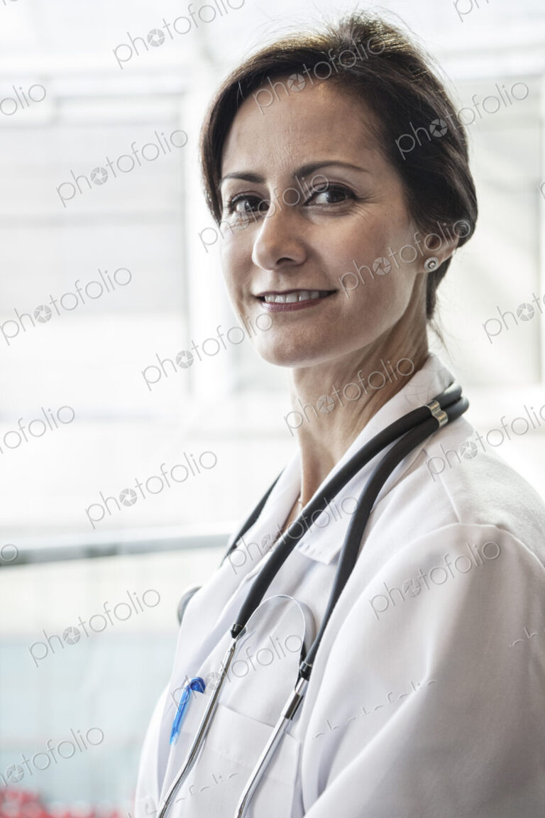 Caucasian female doctor in lab coat with stethescope.