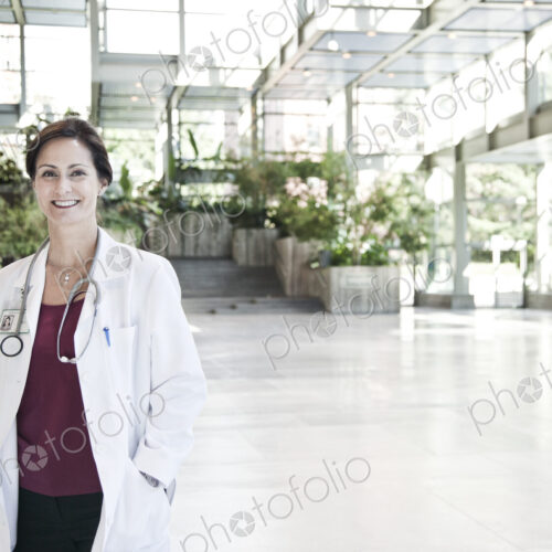 Caucasian female doctor in lab coat with stethescope.