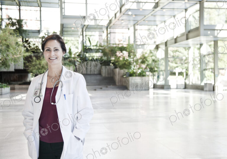 Caucasian female doctor in lab coat with stethescope.