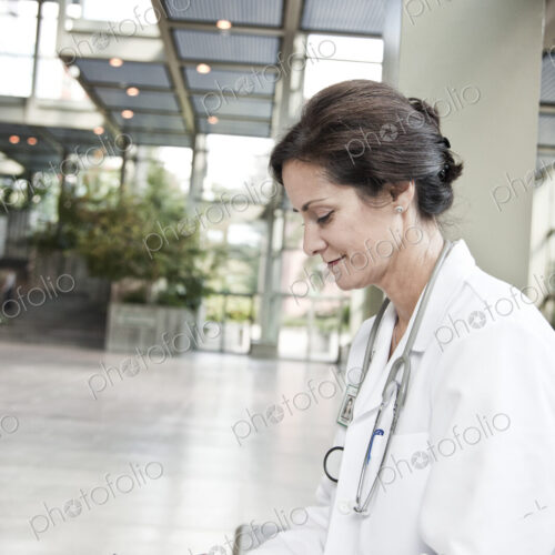 Caucasian female doctor in lab coat with stethescope. Caucasian female doctor in lab coat with stethescope.