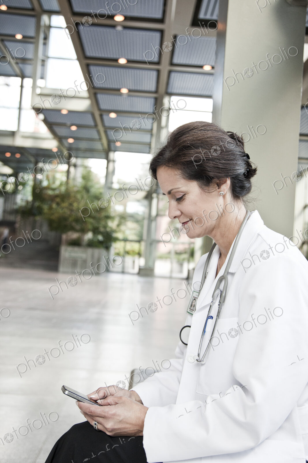Caucasian female doctor in lab coat with stethescope.