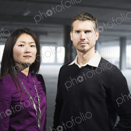 Caucasian male and Asian female business owners in a new raw business space. Caucasian male and Asian female business owners in a new raw business space.