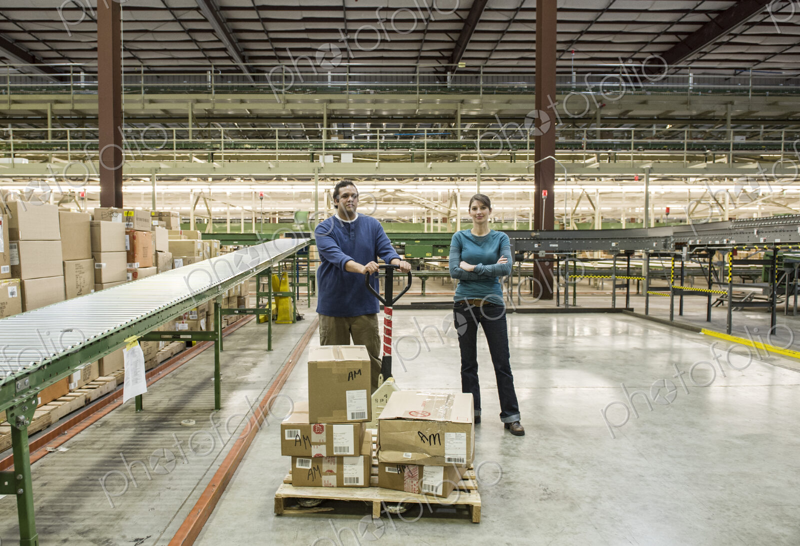 Caucasian male and female workers in a large distribution warehouse.