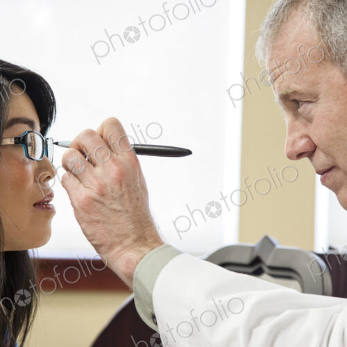 Caucasian male ophthalmologist working with an asian woman who is purchasing a new… Caucasian male ophthalmologist working with an asian woman who is purchasing a new…