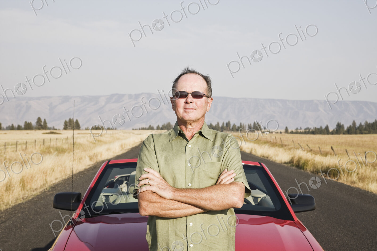 Caucasian man and his car parked on a highway