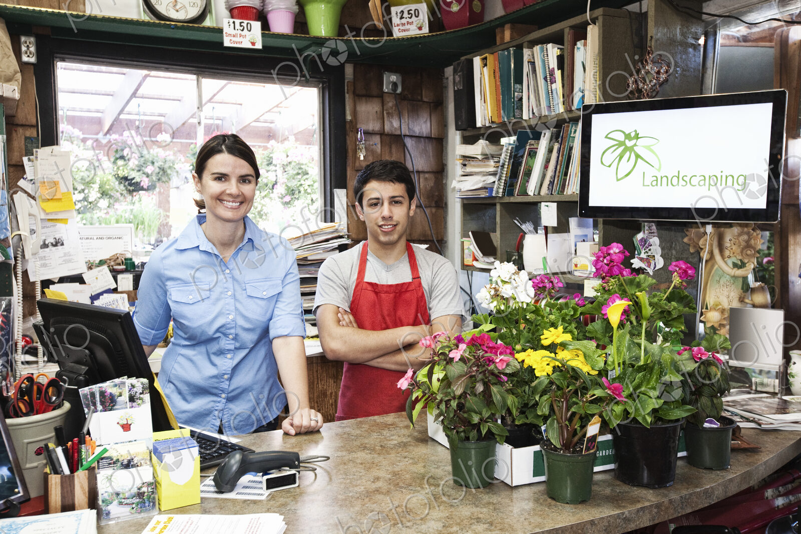 Caucasian man and woman employees of a garden center nursery.