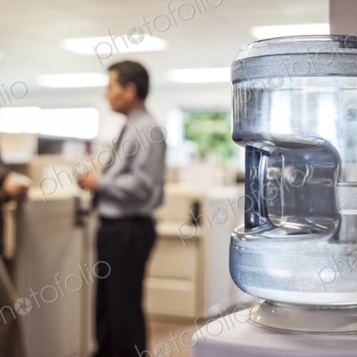 Caucasian man and woman executives in cubicle area of new office space