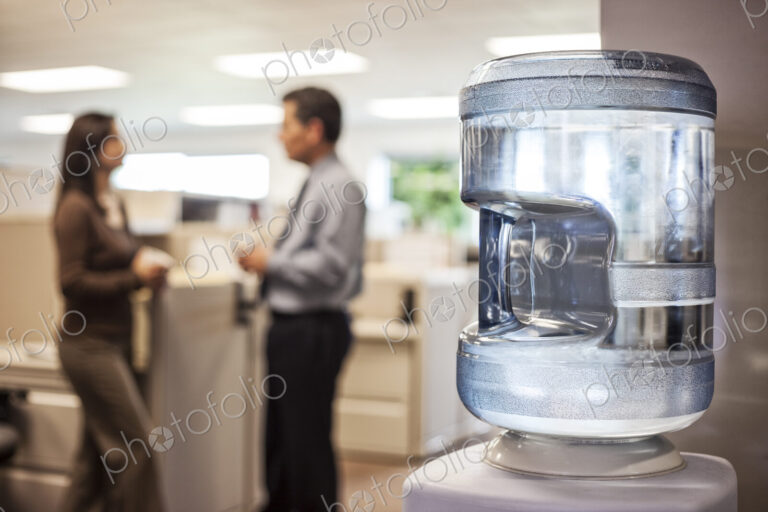 Caucasian man and woman executives in cubicle area of new office space