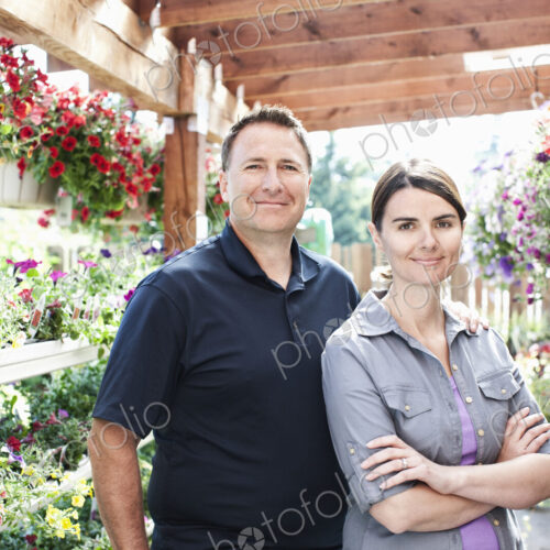 Caucasian man and woman owners of a small plant nursery. Caucasian man and woman owners of a small plant nursery.