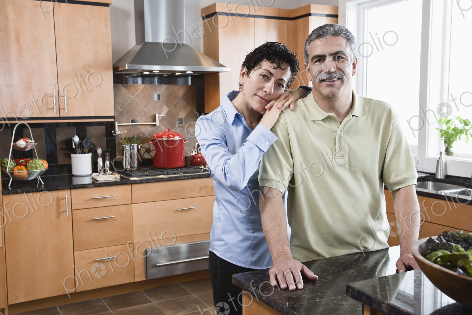 Caucasian man and woman preparing a meal in their new kitchen.