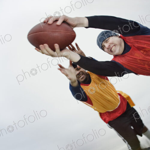 Caucasian man being tackled by an opponent,and diving with arms outstretched to score,… Caucasian man being tackled by an opponent,and diving with arms outstretched to score,…
