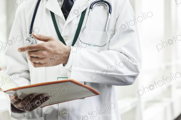 Caucasian man doctor going over a patient history.