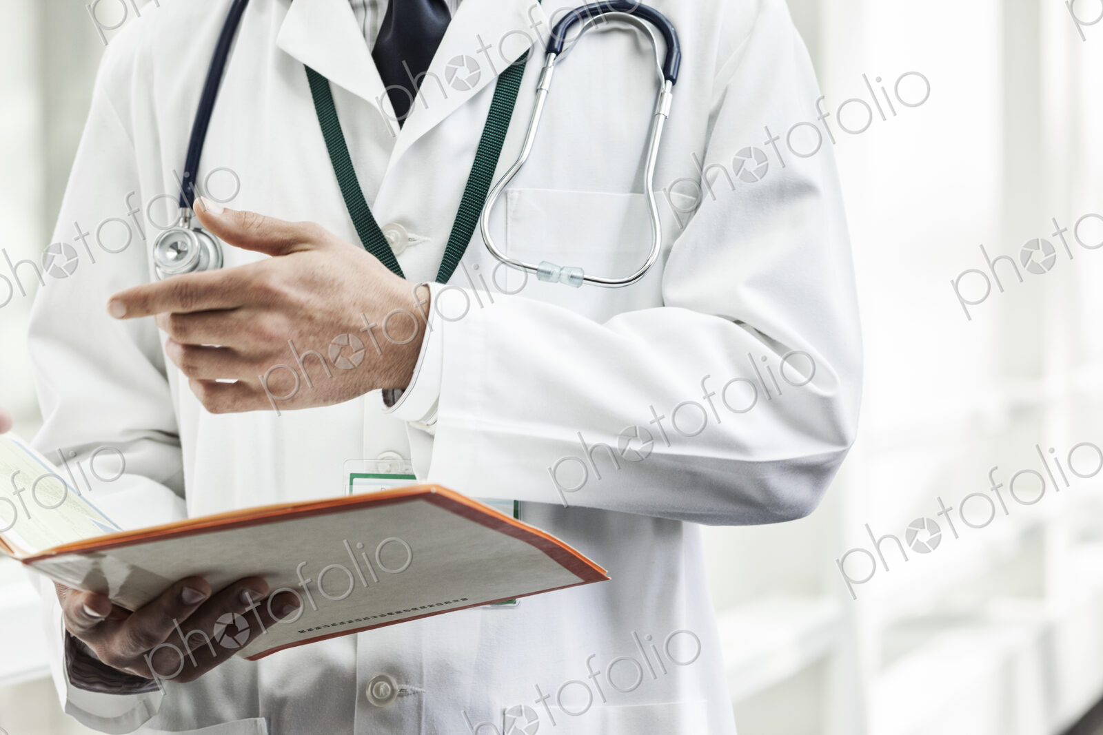 Caucasian man doctor going over a patient history.