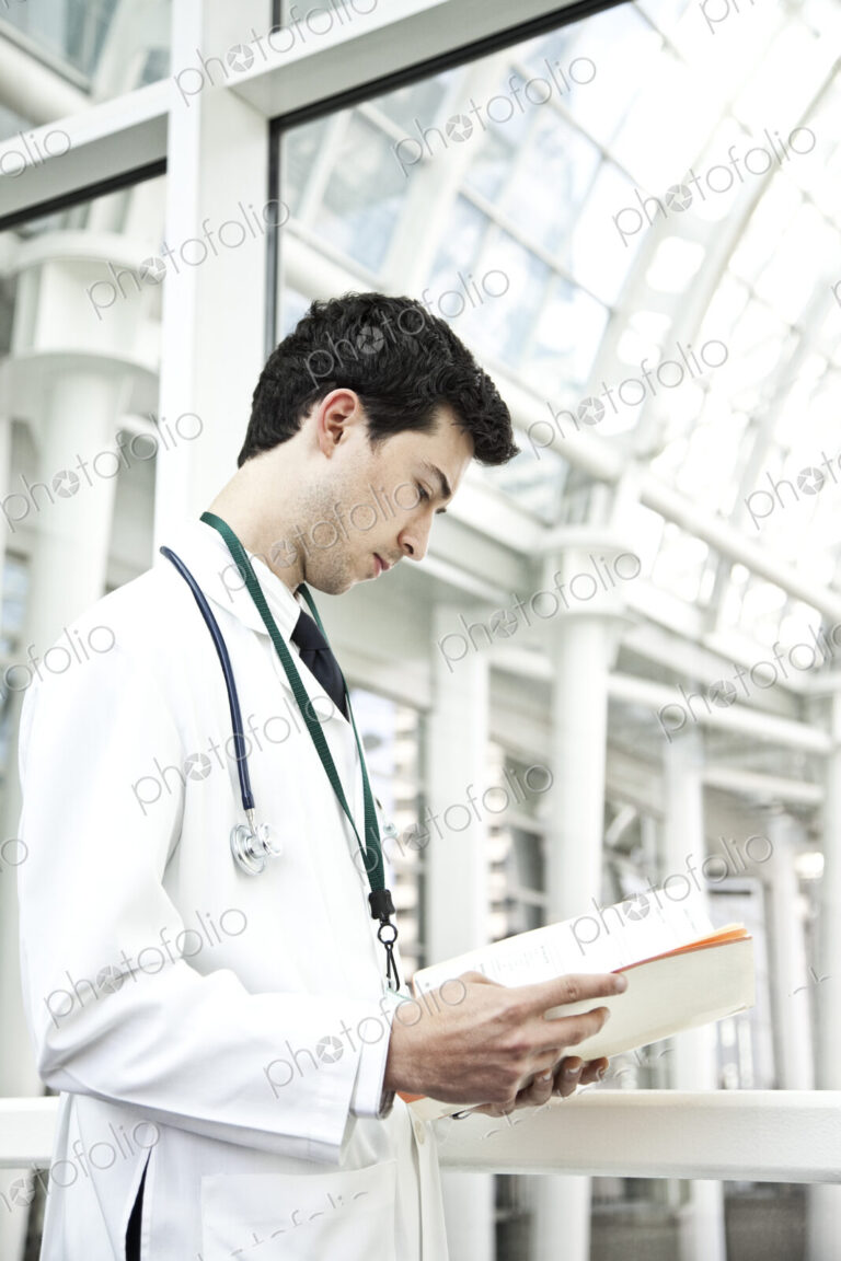 Caucasian man doctor going over a patient history.