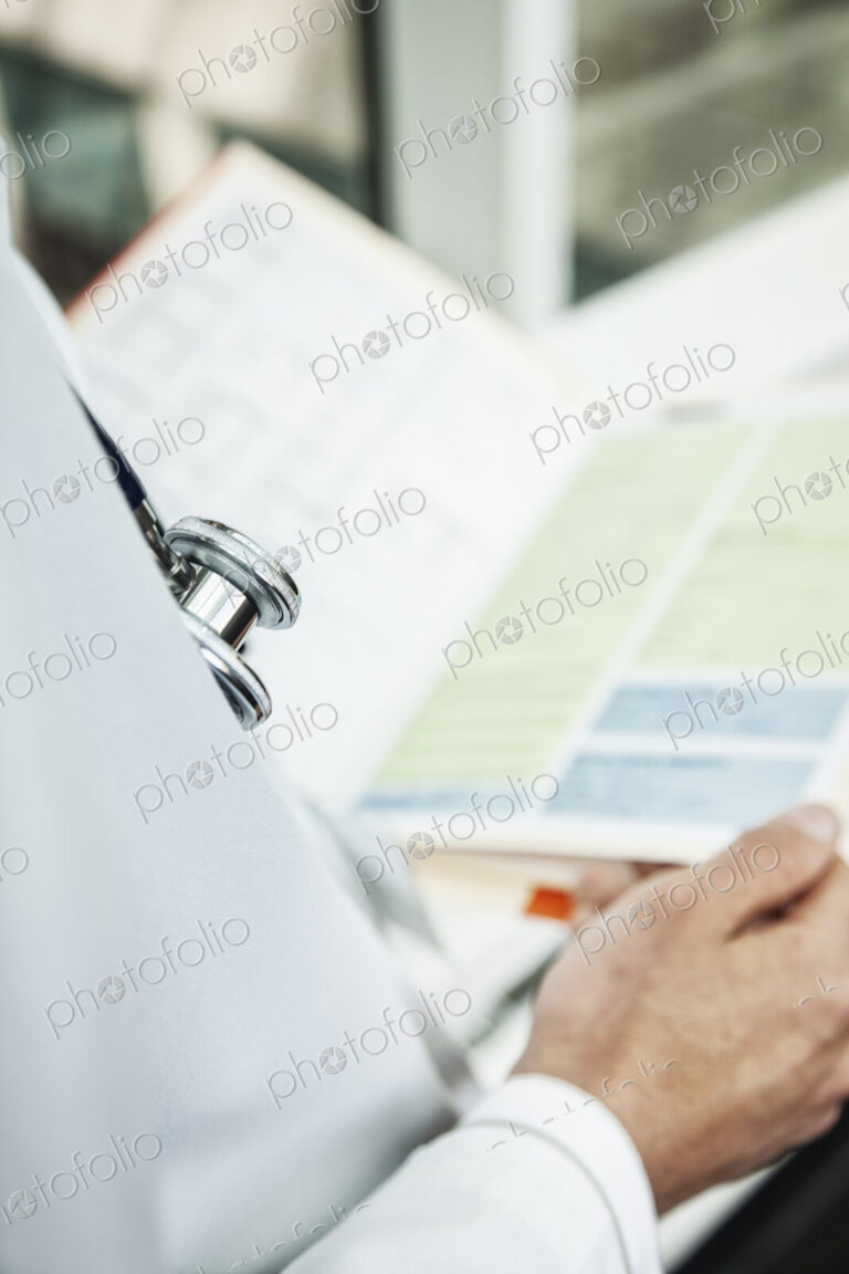 Caucasian man doctor going over a patient history.