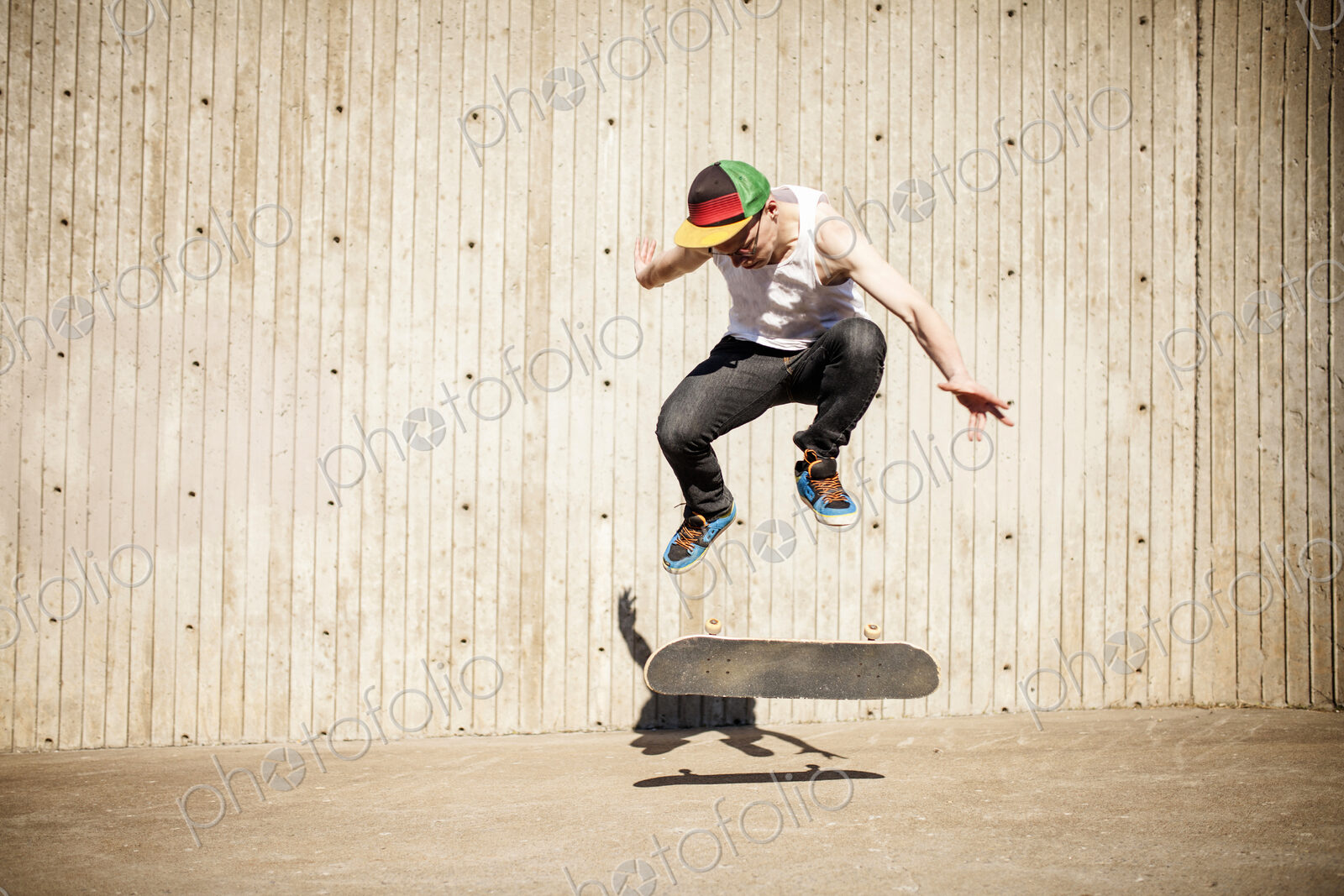 Caucasian man doing skate trick near wooden wall