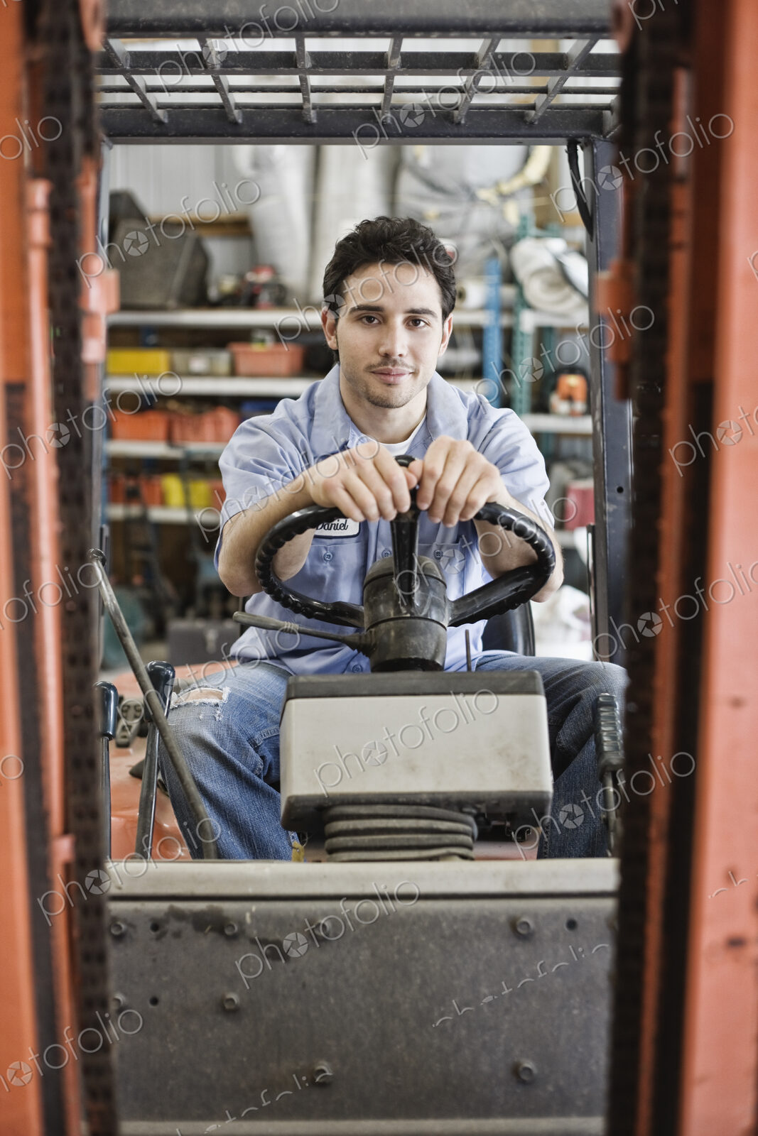 Caucasian man employee driving a forklift for a landscape company.